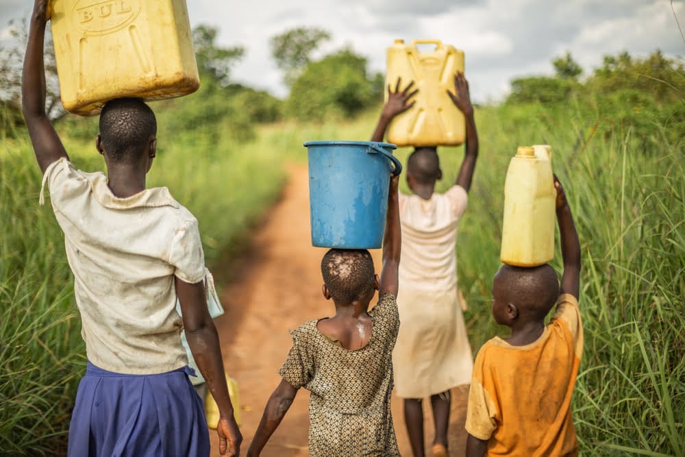 Children carrying water jerrycans